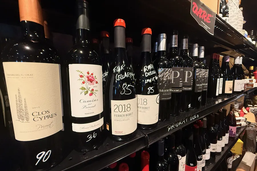 La Vid’s Priorat shelf: Clos Cypres, Camins del Priorat, and Ferrer Bobet among bottles with handwritten prices