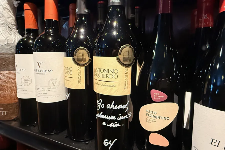 Antonino Izquierdo, Ribera del Duero, on La Vid’s shelf with Victor’s note in white marker: “Go ahead, pleasure isn’t a sin.” Valtravieso and Pago Florentino beside it